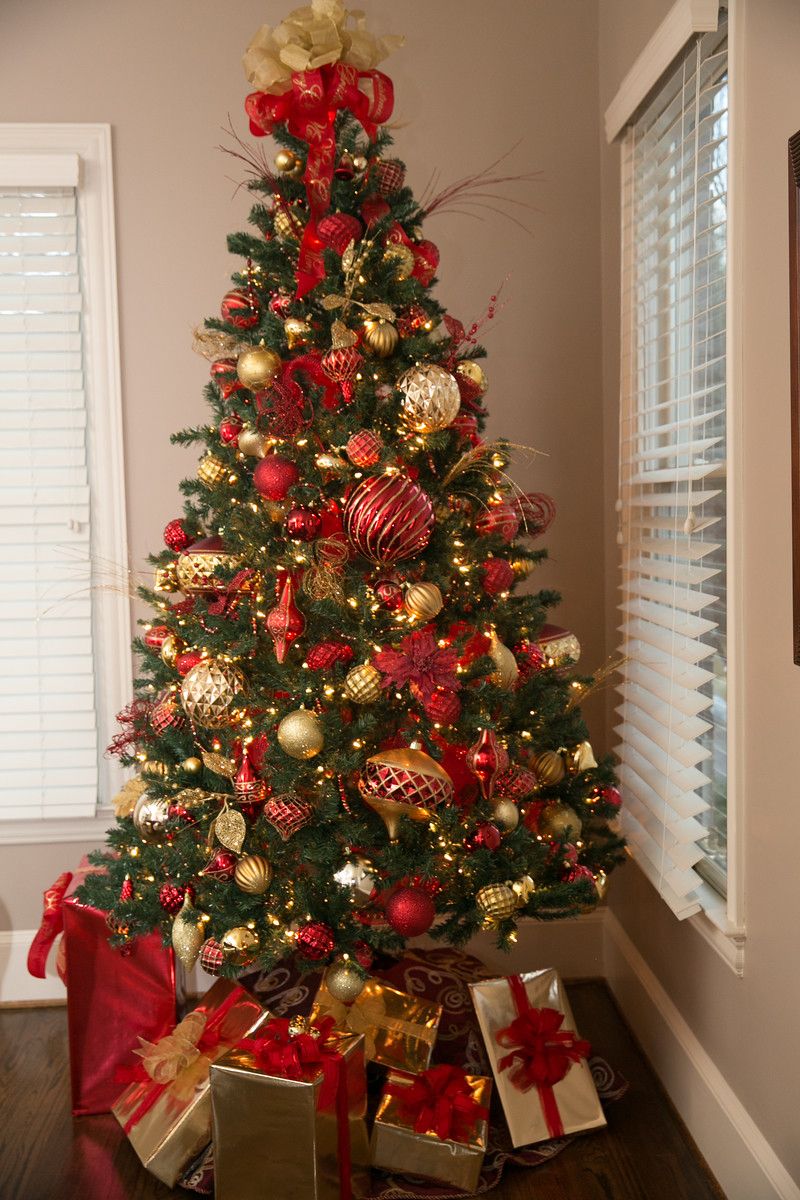 Flocked Christmas Tree With Red And Gold Decorations